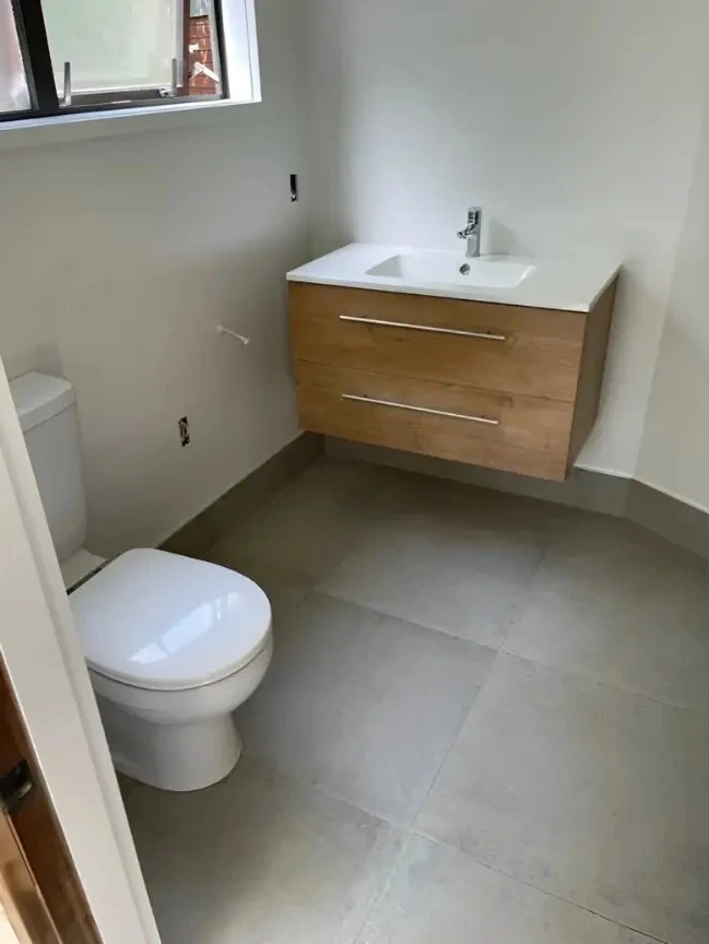 Contemporary bathroom renovations Wellington in New Zealand featuring a floating vanity and sleek toilet.